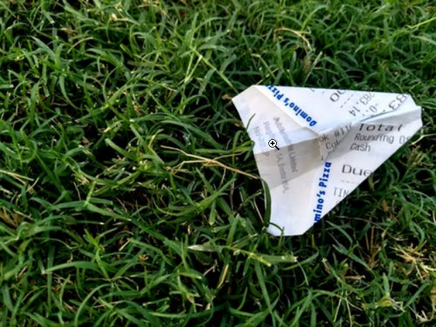 a paper receipt on the grass